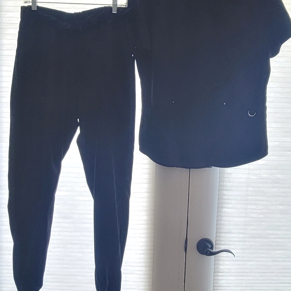 2 sets of scrubs. Soft and like new. L/XL, black and navy blue